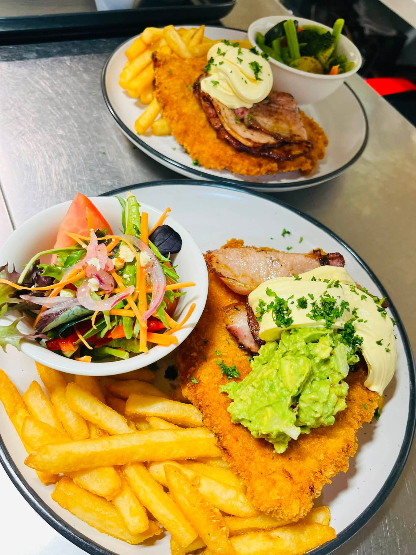 Chicken parmas with chips, salad and seasonal vegetables
