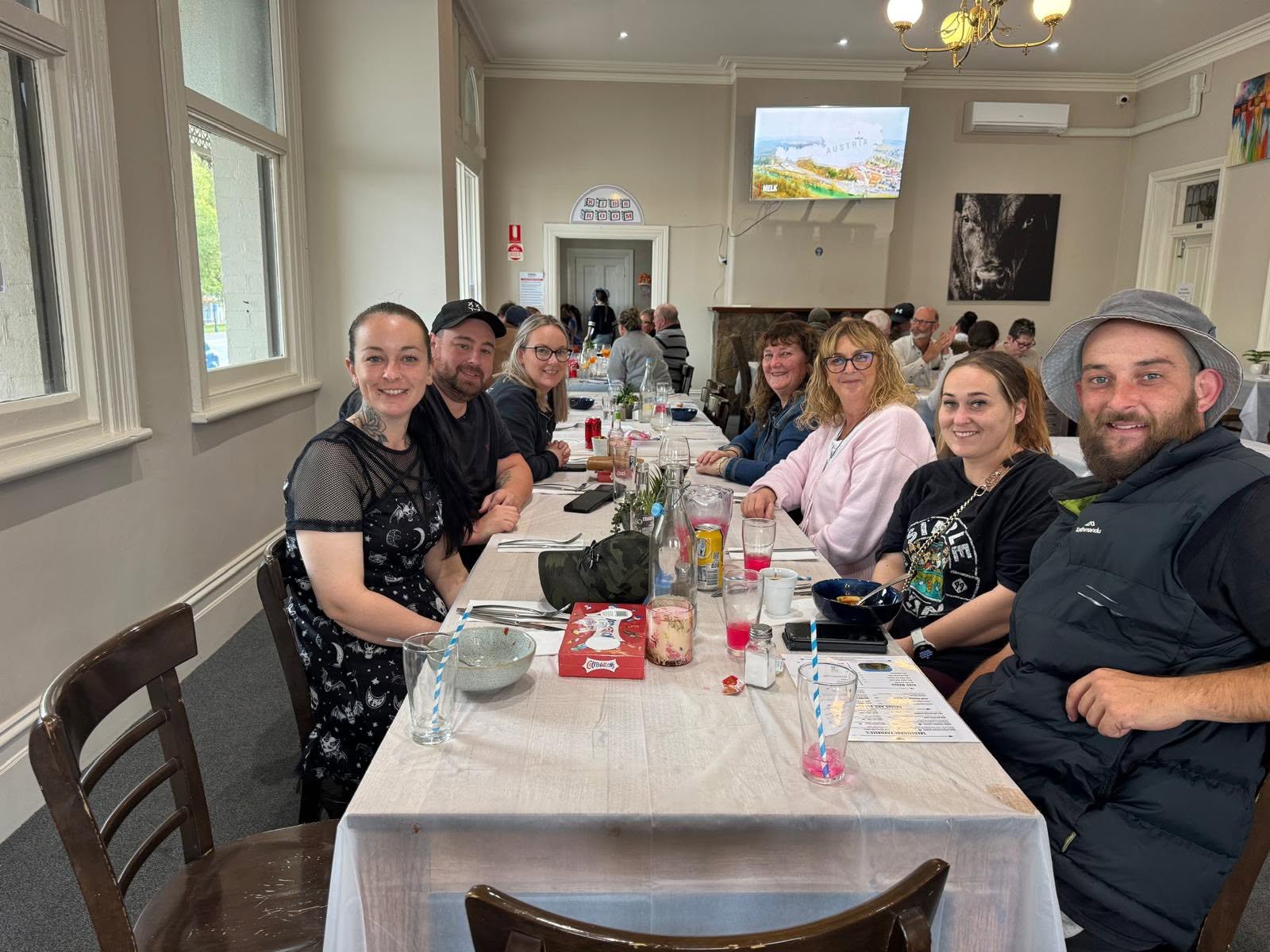 A long table of friends in the dining room