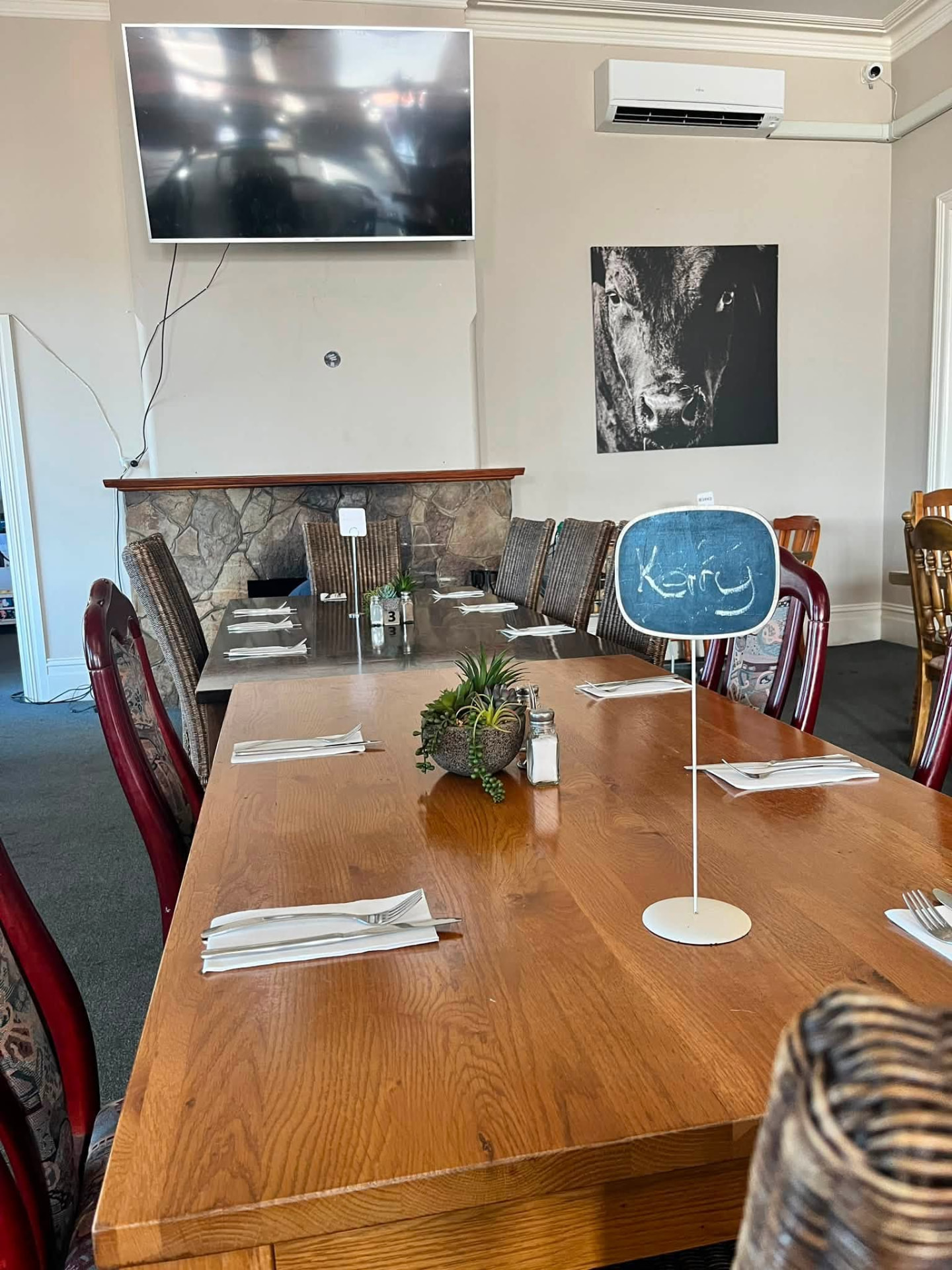 Reserved dining table by the stone fireplace