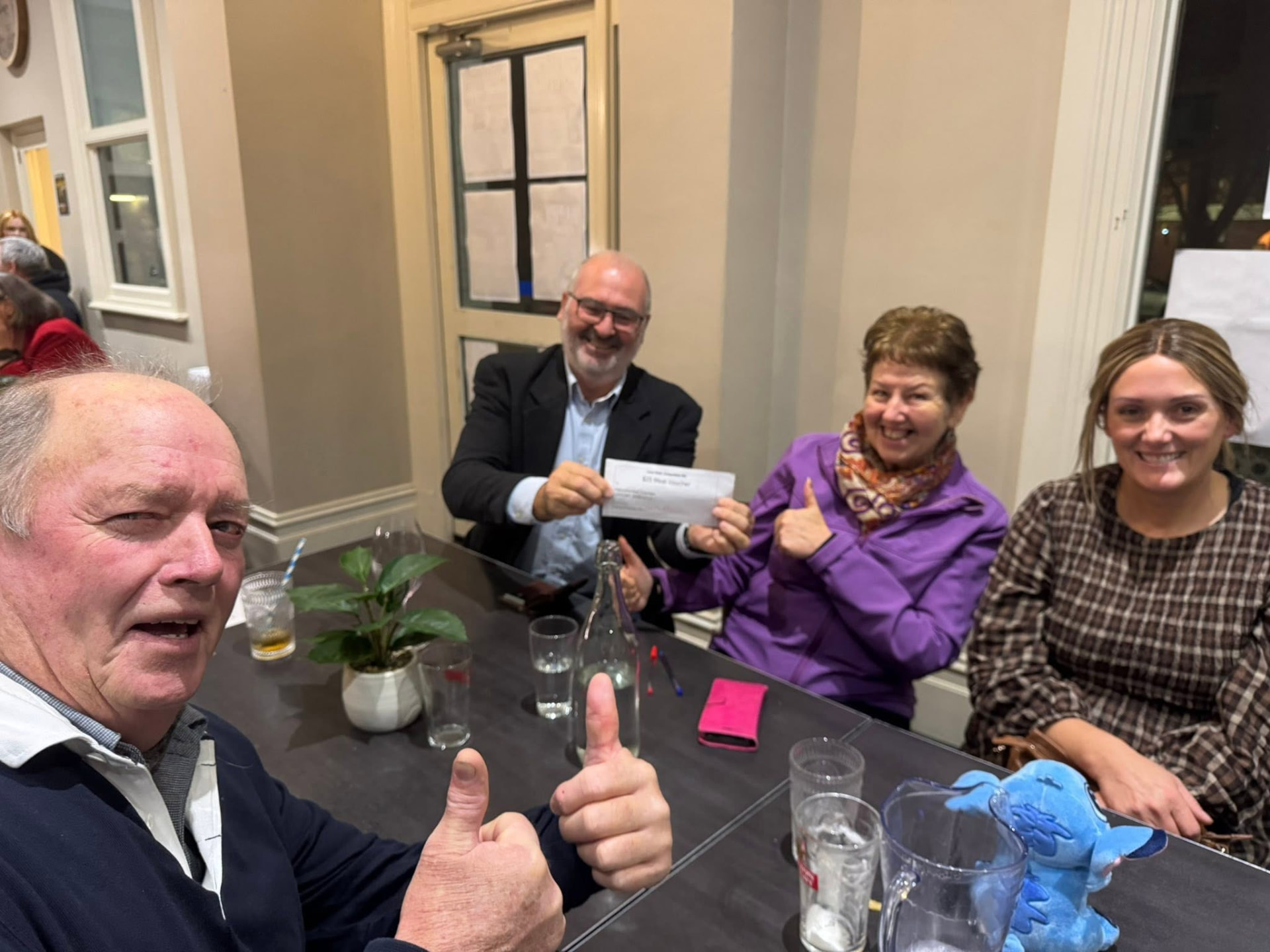 Trivia night winners with their meal voucher